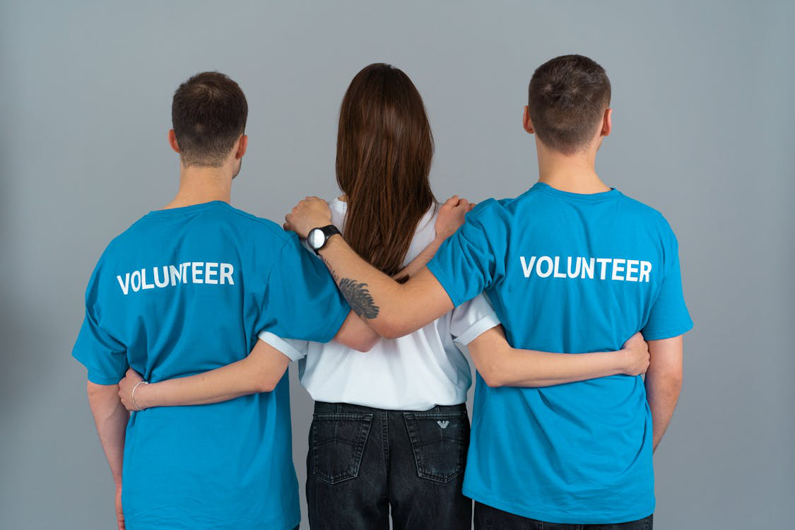 Volunteers standing with their hands around each other’s waists